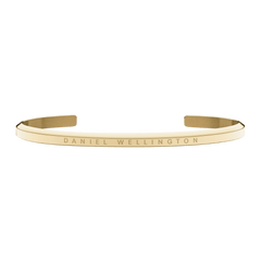 Minimalist Classic Bracelet Gold with a polished finish, featuring an engraved Daniel Wellington logo on a slim, adjustable gold cuff suitable for layering or everyday wear.