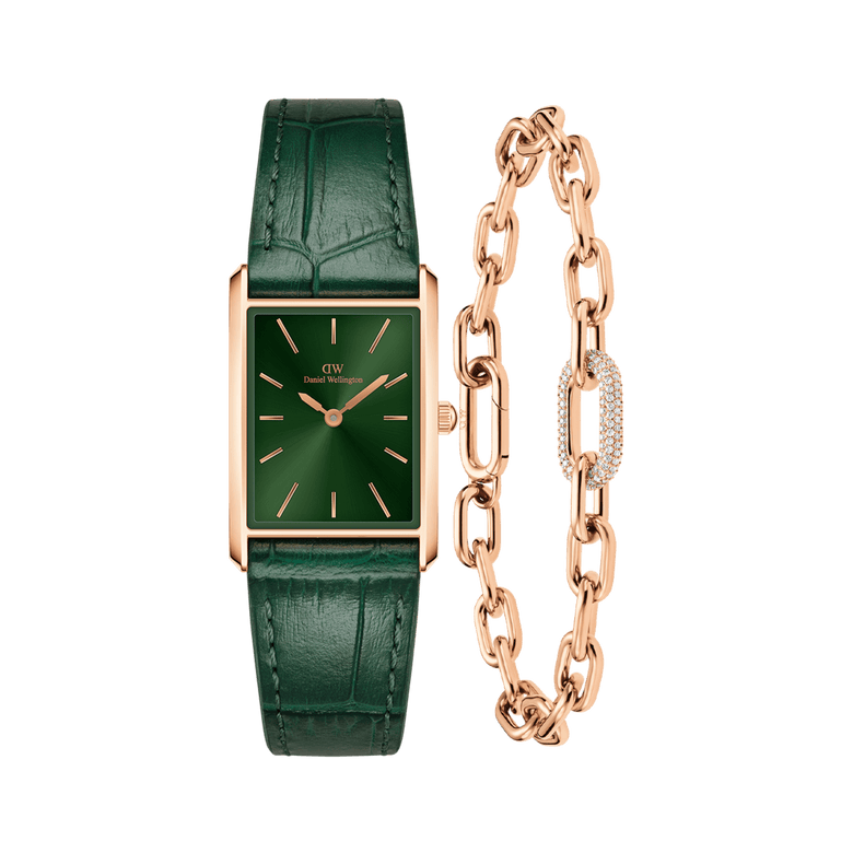 Rectangular emerald sunray dial watch with a crocodile-embossed green leather strap in rose gold, paired with a rose gold crystal link bracelet featuring pavé crystal detailing and adjustable chain links.
