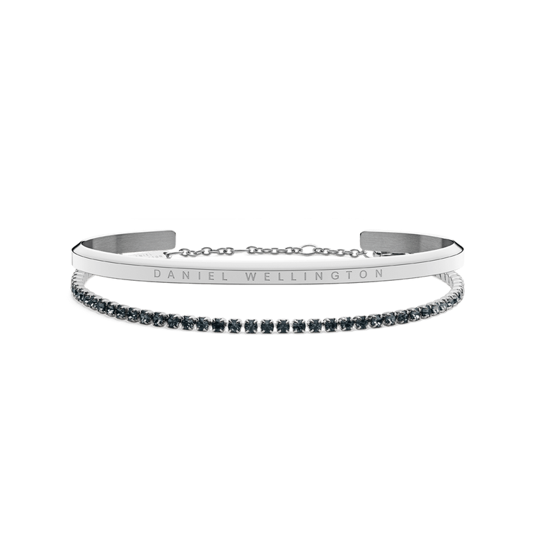 Classic Bracelet Silver and Tennis Bracelet Nightfall Silver set featuring a polished silver cuff with subtle branding and a delicate tennis bracelet adorned with deep nightfall-toned stones, displayed side by side against a plain background.