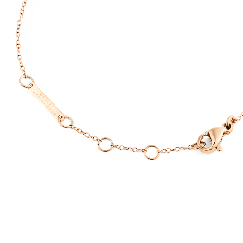 Detail of the Mirelle Solitaire Bracelet Rose Gold showing the adjustable rose gold chain, secure clasp, and Daniel Wellington engraved tag.