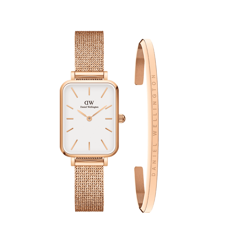 Rectangular rose gold Daniel Wellington ladies watch with a white dial and pressed mesh strap, paired with a slim rose gold bracelet engraved with the Daniel Wellington logo, both styled for a refined and modern look.