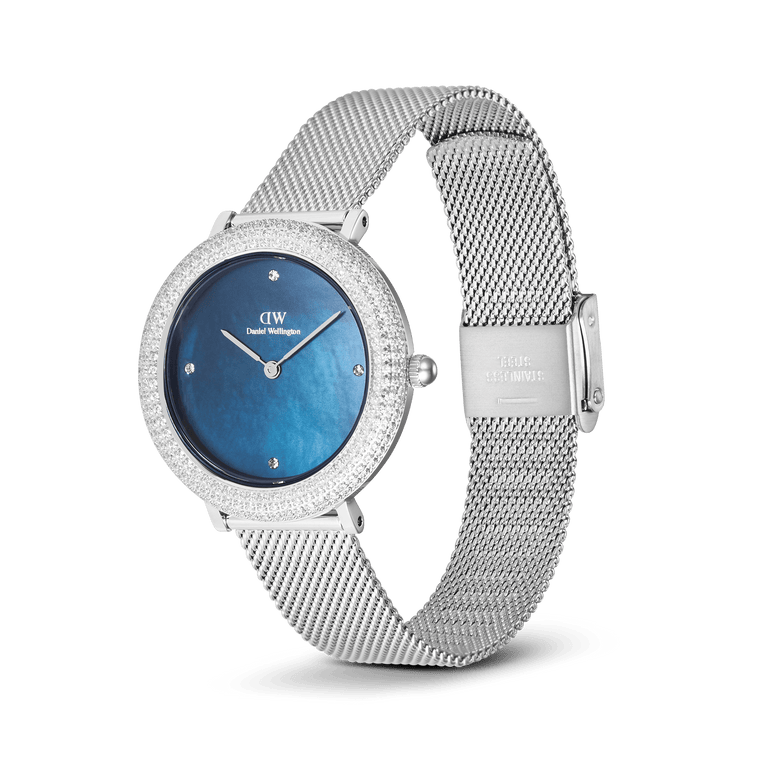 Crystalline Bezel Sterling Blue ladies watch by Daniel Wellington featuring a blue mother of pearl dial, crystal-set bezel, and an adjustable silver stainless steel mesh strap.