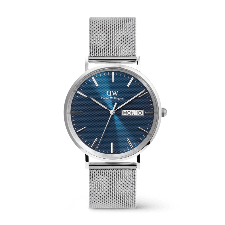 Classic Day Display Sterling Arctic men's watch featuring a blue dial with a semi-transparent triangle pattern, day and date window, and a stainless steel mesh strap with a safety buckle.