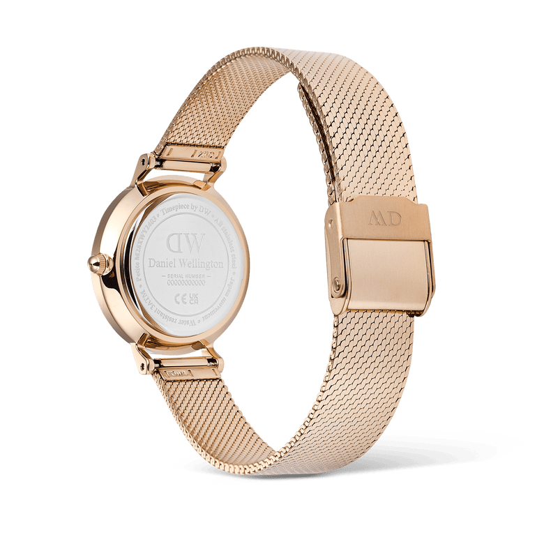 Daniel Wellington Petite Reflection Rose Gold watch showing the stainless steel case back, engraved details, and adjustable rose gold mesh strap with a secure clasp.