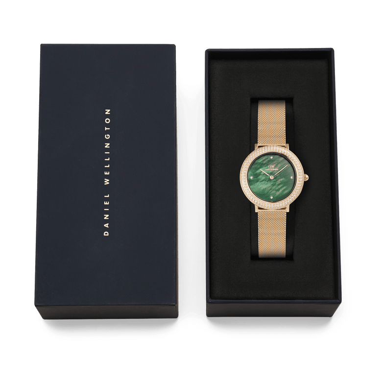 Crystalline Bezel Evergold Green gold ladies watch with a green mother of pearl dial and crystal-set bezel, presented in a Daniel Wellington branded gift box.