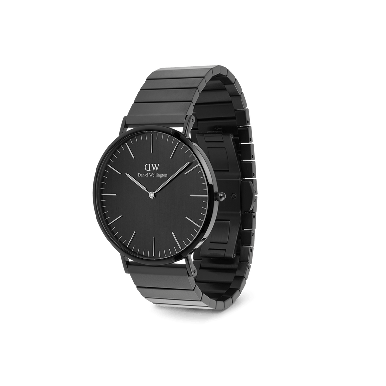 Classic Piano Link Onyx Unitone Black watch by Daniel Wellington displayed at an angle, featuring a brushed black dial, minimalist markers, and a geometric stainless steel piano link bracelet.