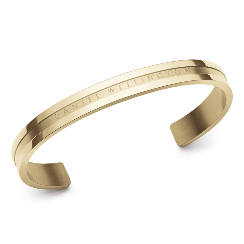 Elan Bracelet Gold featuring a polished gold finish, minimalist open cuff design, and engraved Daniel Wellington branding, crafted from stainless steel for a modern, elegant look.