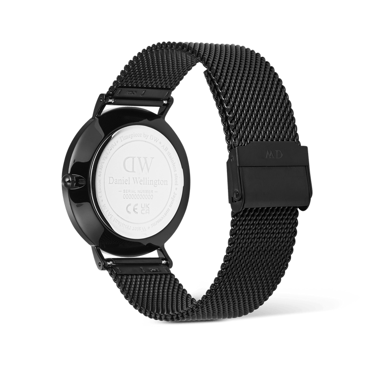 Rear view of the Classic Day Display Onyx Black watch, highlighting the engraved stainless steel case back and the adjustable black mesh strap.