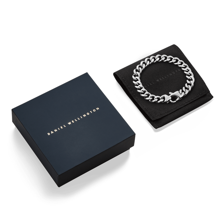 Ellipse Cuban Chain Bracelet Silver displayed on a black pouch next to a Daniel Wellington gift box, showcasing its polished chunky links and elegant presentation for gifting.