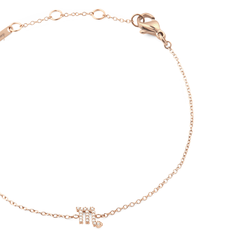 Close-up of the Crystal Zodiac Chain Bracelet Rose Gold, featuring a slim rose gold chain, adjustable sizing rings, and a crystal-set Scorpio zodiac pendant.
