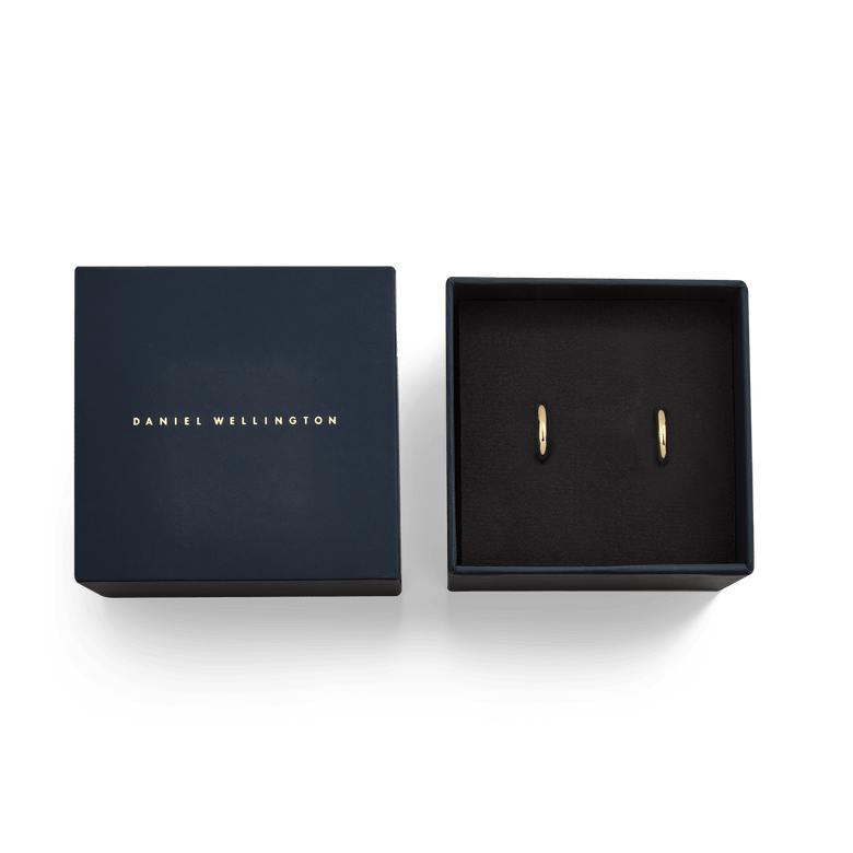 Arch Earring Gold 9mm pair presented in a navy Daniel Wellington gift box, highlighting the minimalist gold hoop earrings as an elegant gifting option.