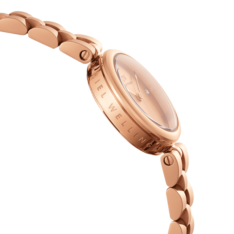 Close-up side view of the Elan Lumine Unitone Rose Gold ladies watch, showing the engraved case, crystal-dotted dial, and polished rose gold bracelet links.