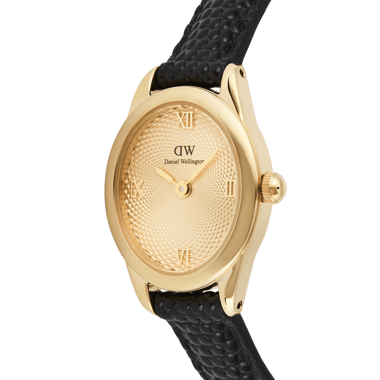 Close-up of the Daniel Wellington Ophelia Mini Black Lizard Unitone Guilloché Gold watch, highlighting the gold oval case, textured guilloché dial with Roman numerals, and black lizard-embossed leather strap.