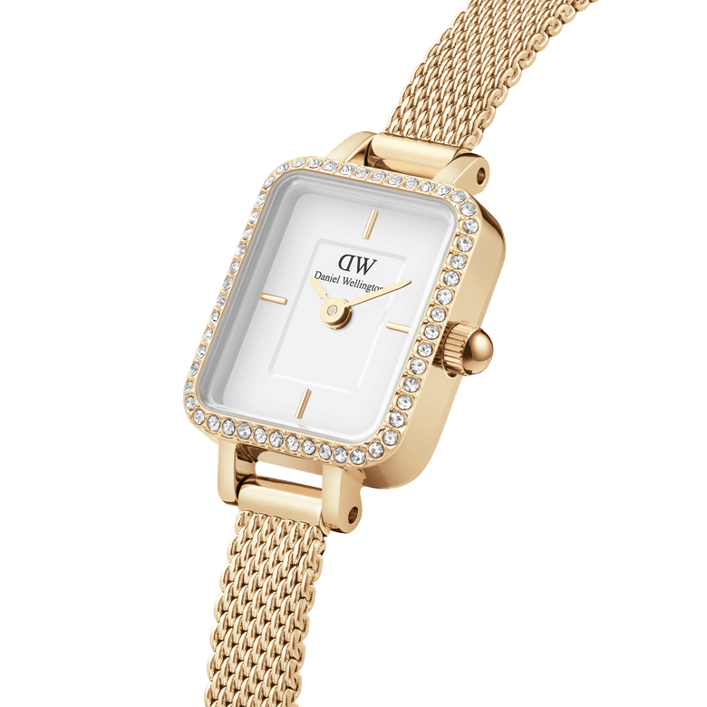 Quadro Mini Lumine Bezel Gold ladies watch featuring a rectangular white dial, sparkling crystal bezel, and a textured gold mesh strap, shown in a close-up to highlight its elegant detailing.