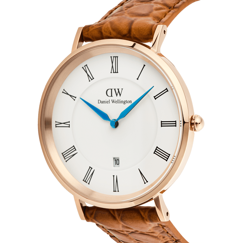 Close-up of the Classic Roman Numerals Date Light Brown Croc Belly Rose Gold watch, highlighting the rose gold case, white dial with black Roman numerals, blue hands, date window at six o’clock, and textured light brown croc-embossed leather strap.