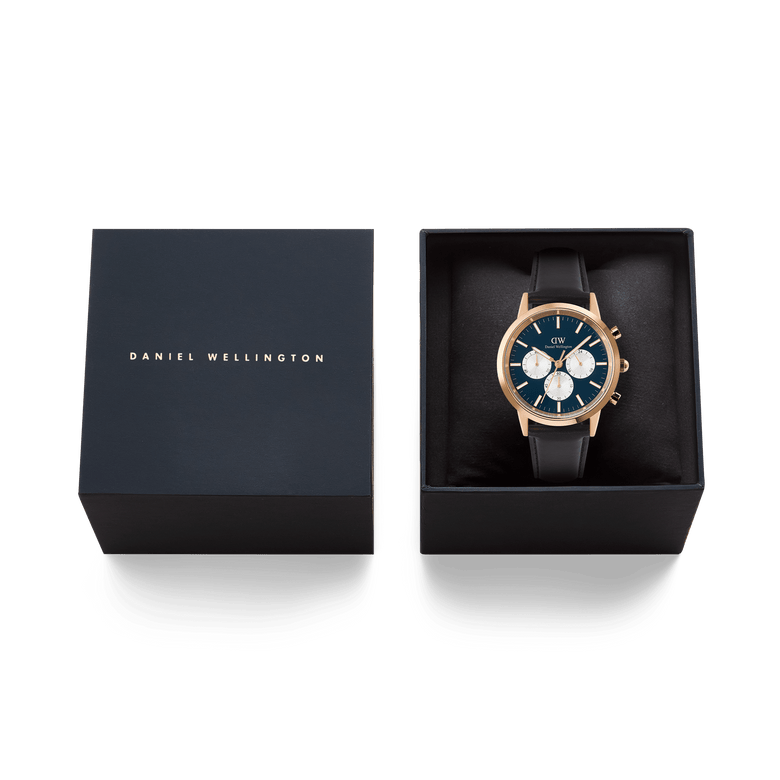 Iconic Chronograph Sheffield Arctic Panda Rose Gold watch with a deep blue dial, white sub-dials, and black leather strap, presented in a branded Daniel Wellington gift box.