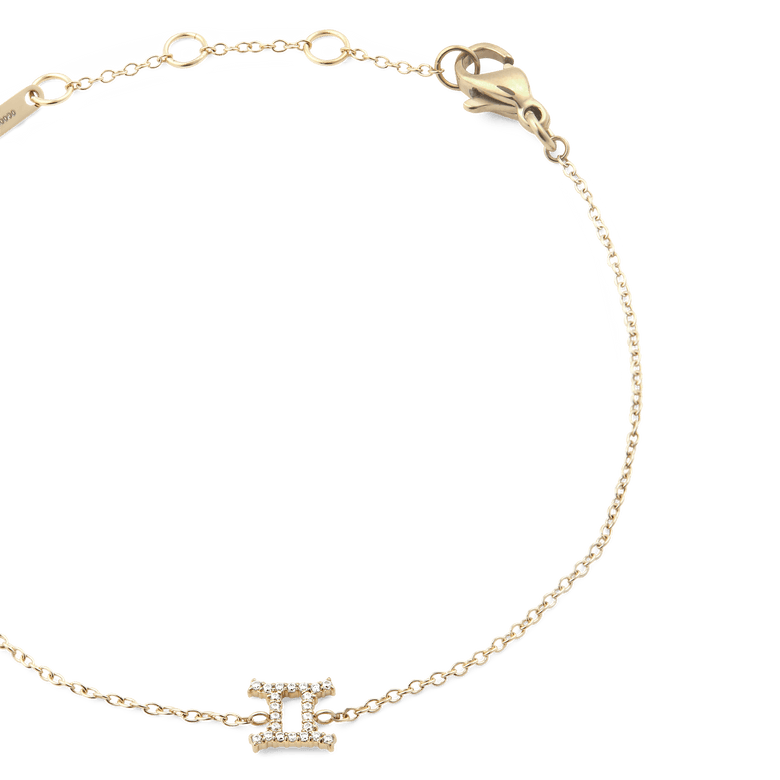 Close-up of the Crystal Zodiac Chain Bracelet Gold with a fine gold chain, adjustable sizing rings, and a crystal-encrusted Gemini zodiac charm at the centre.