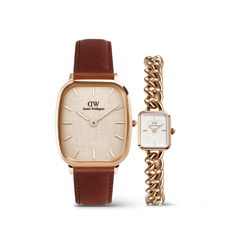 The Marlon & Jolie Chain Rose Gold Set features a men’s Daniel Wellington watch with a cushion-shaped rose gold case, textured warm white dial, and brown leather strap, paired with a women’s petite rectangular watch with a rose gold chain bracelet and crisp white dial.