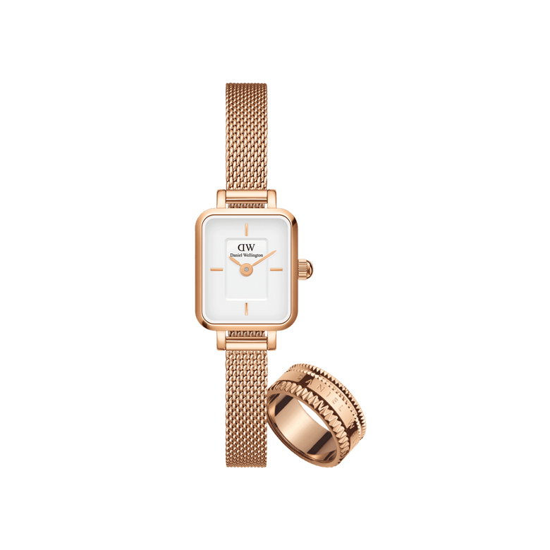 A petite Daniel Wellington ladies watch with a rectangular white dial and rose gold mesh strap, paired with a textured rose gold Elevation Ring, both featuring a polished, elegant finish.