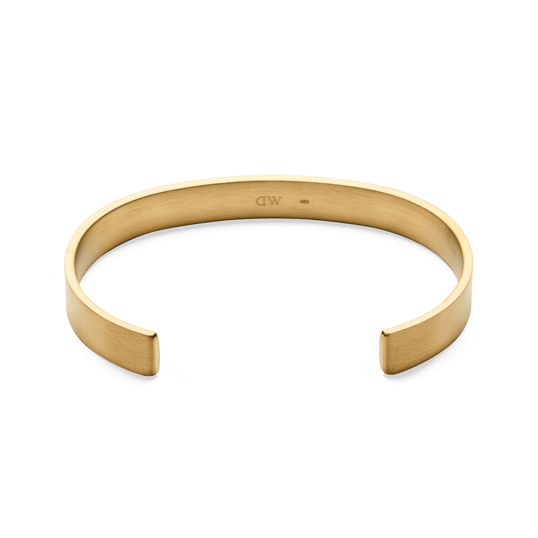 Line Cuff Brushed Gold shown from above, highlighting its open cuff shape, brushed gold finish, and smooth contoured edges for a comfortable fit.