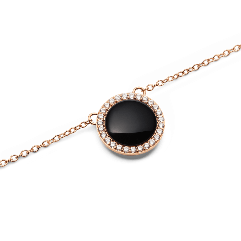 Close-up of the Audrey Necklace Black Agathe Rose Gold pendant, showcasing a domed black agate stone surrounded by a halo of sparkling white cubic zirconia crystals on a delicate rose gold chain.