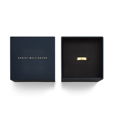 Line Ring Brushed Gold 4.5mm presented in a navy Daniel Wellington gift box, showcasing its matte gold finish and minimalist design as a stylish accessory for men and women.