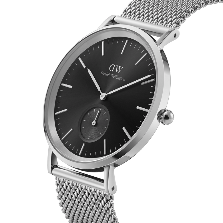 Classic Multi-Eye Sterling Onyx men's watch featuring a black dial, silver mesh strap, minimalist round case, and a seconds subdial, shown in a close-up angle highlighting its polished stainless steel finish.