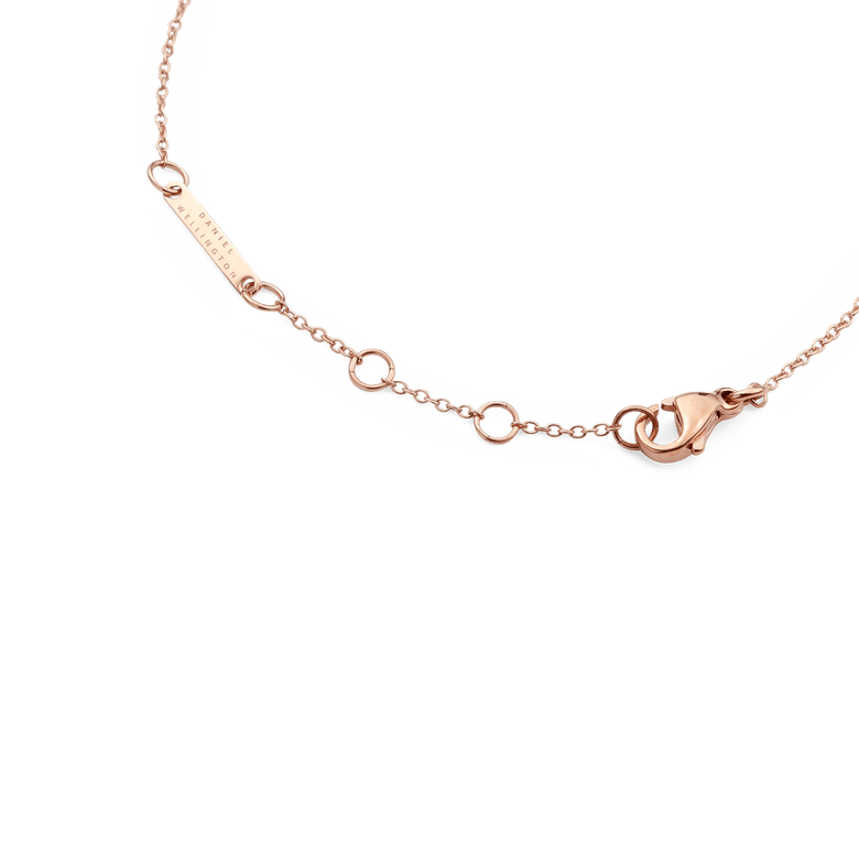 Detail of the Crystal Zodiac Chain Bracelet Rose Gold showing the adjustable sizing rings, secure lobster clasp, and engraved Daniel Wellington tag on a slim rose gold chain.