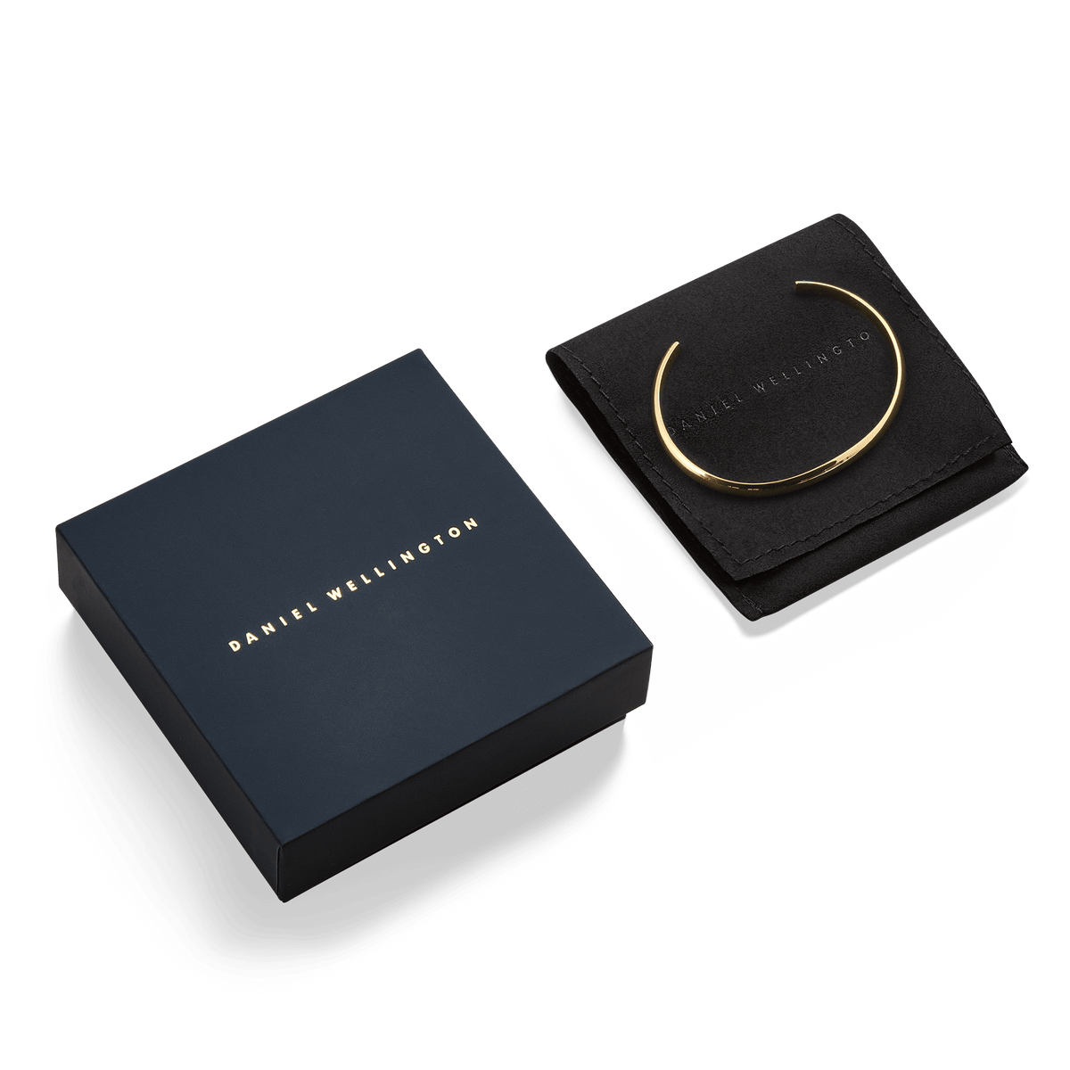 Arch Cuff Gold 6mm gold bracelet displayed on a branded black pouch next to an elegant Daniel Wellington gift box, highlighting its polished finish and premium packaging ideal for gifting.