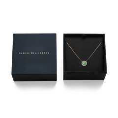 Audrey Necklace Jade Rose Gold presented in a Daniel Wellington gift box, featuring a rose gold chain and a round green jade pendant surrounded by white cubic zirconia crystals.