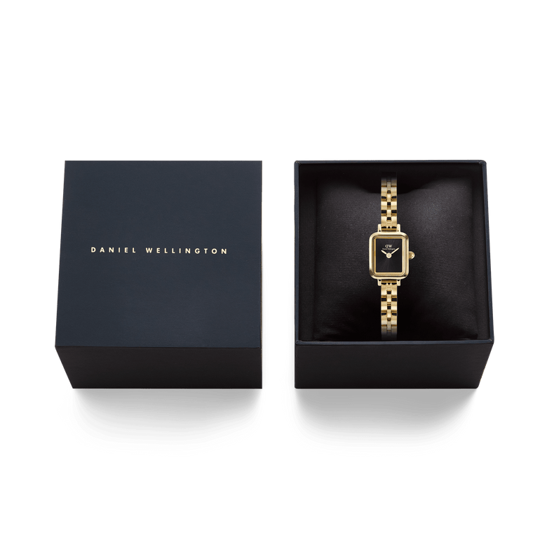 Quadro Mini Arch 3-link Onyx Sunray Gold ladies watch presented in a black Daniel Wellington gift box, featuring a rectangular gold case, black dial, and polished gold-plated bracelet.
