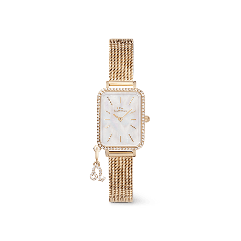 Gold rectangular ladies watch with a crystal-set bezel, white mother of pearl dial, gold mesh strap, and a removable zodiac charm attached, from the Quadro Crystal Zodiac Evergold Set by Daniel Wellington.
