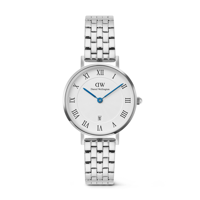 Petite Roman Numerals Date 5-link Silver watch with a white guilloché dial, bold Roman numerals, blue hands, and a polished silver 5-link stainless steel bracelet, featuring a date window at 6 o’clock.