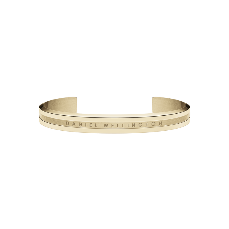 Slim gold cuff bracelet with a minimalist design, featuring engraved Daniel Wellington branding and a polished finish suitable for everyday wear or special occasions.