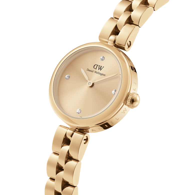 Elan Lumine Unitone Gold ladies watch featuring a gold crystal dial, three-link bracelet, and engraved Daniel Wellington branding, shown in a close-up to highlight its elegant and minimalist design.