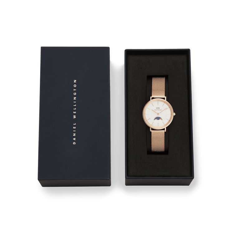 Petite Lune Melrose rose gold ladies watch with mesh strap and moon-phase sub-dial, presented in a branded Daniel Wellington gift box, ideal for gifting or special occasions.