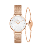 Rose gold Daniel Wellington Petite Lumine Pressed Piano watch with a textured mesh strap and crystal hour markers, paired with an Elan Unity Bracelet featuring an adjustable chain and unity ring detail, both designed for elegant, petite wrists.