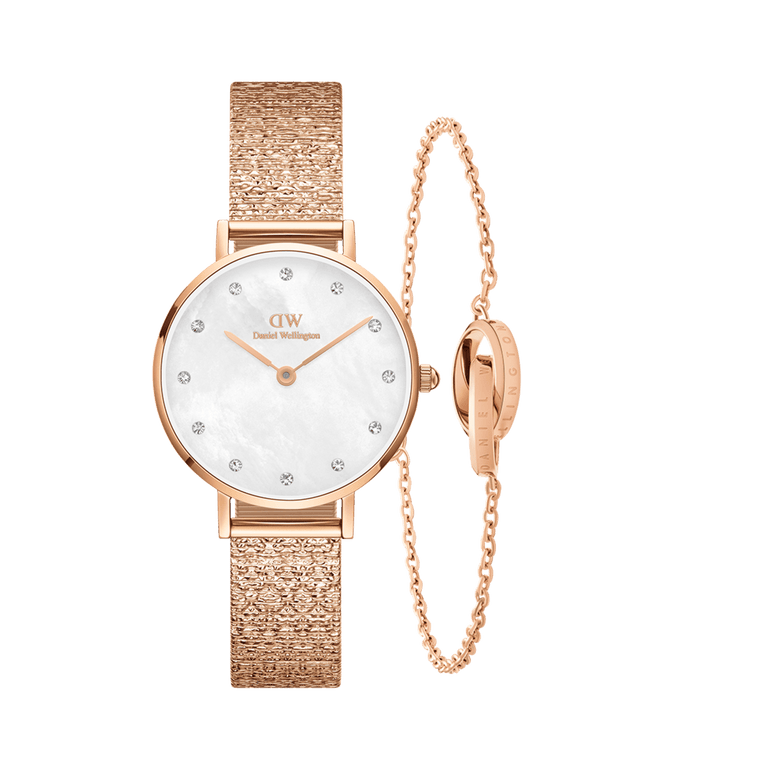 Rose gold Daniel Wellington Petite Lumine Pressed Piano watch with a textured mesh strap and crystal hour markers, paired with an Elan Unity Bracelet featuring an adjustable chain and unity ring detail, both designed for elegant, petite wrists.