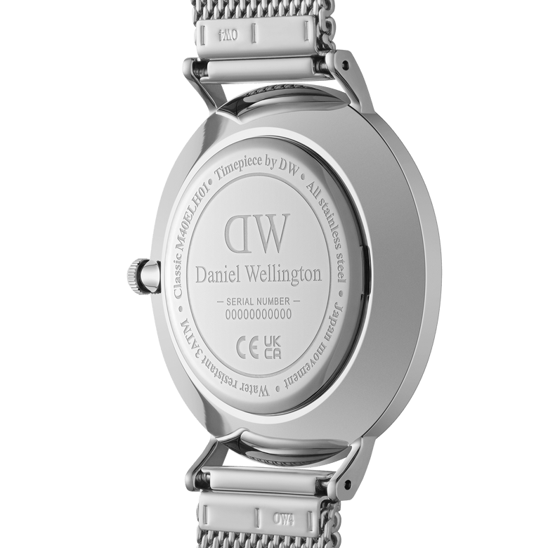 Close-up of the Classic Multi-Eye Sterling Onyx men's watch case back, showing engraved branding, stainless steel construction, water resistance details, and the silver mesh strap attachment.