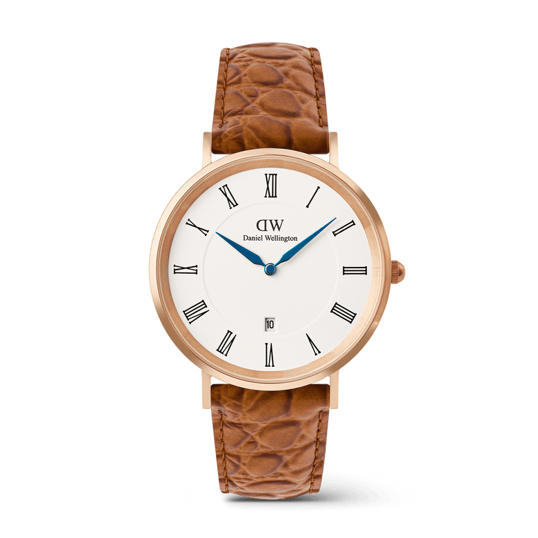 Classic men’s watch with a rose gold case, crisp white dial featuring black Roman numerals, blue hands, a date window at six o’clock, and a light brown croc-embossed leather strap.