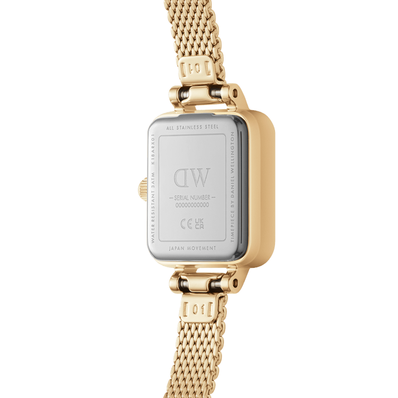 Quadro Mini Evergold gold watch showing the stainless steel case back, engraved details, and gold mesh strap, highlighting its Japanese movement and water resistance.