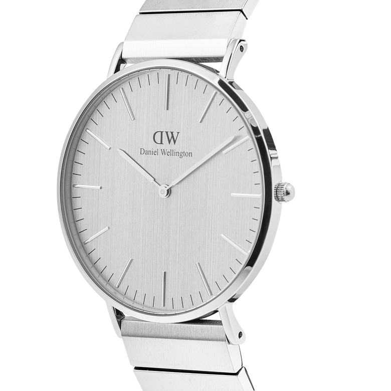 Classic Piano Link Silver Unitone men's watch with a brushed silver 40mm dial, minimalist hour markers, and a stainless steel piano link bracelet, shown from a side angle to highlight its slim profile and polished finish.