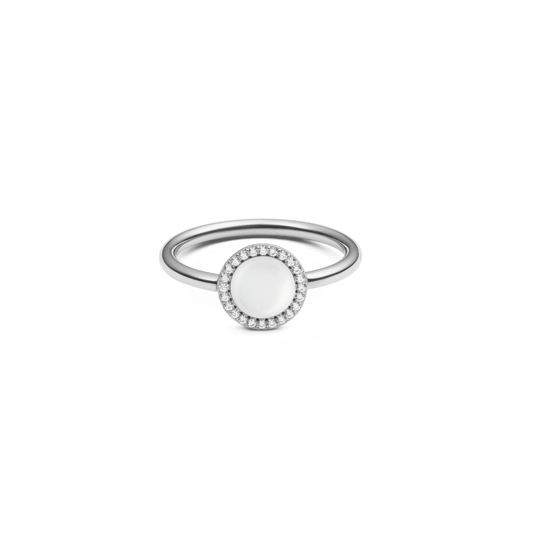 Silver ring with a round mother of pearl centrepiece, surrounded by a halo of white cubic zirconia on a slim, minimalist band.