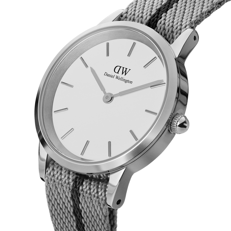 Close-up of the Daniel Wellington Iconic NATO Grey/Black watch showing its minimalist white dial, polished stainless steel case, and textured grey and black NATO strap with a twill weave.