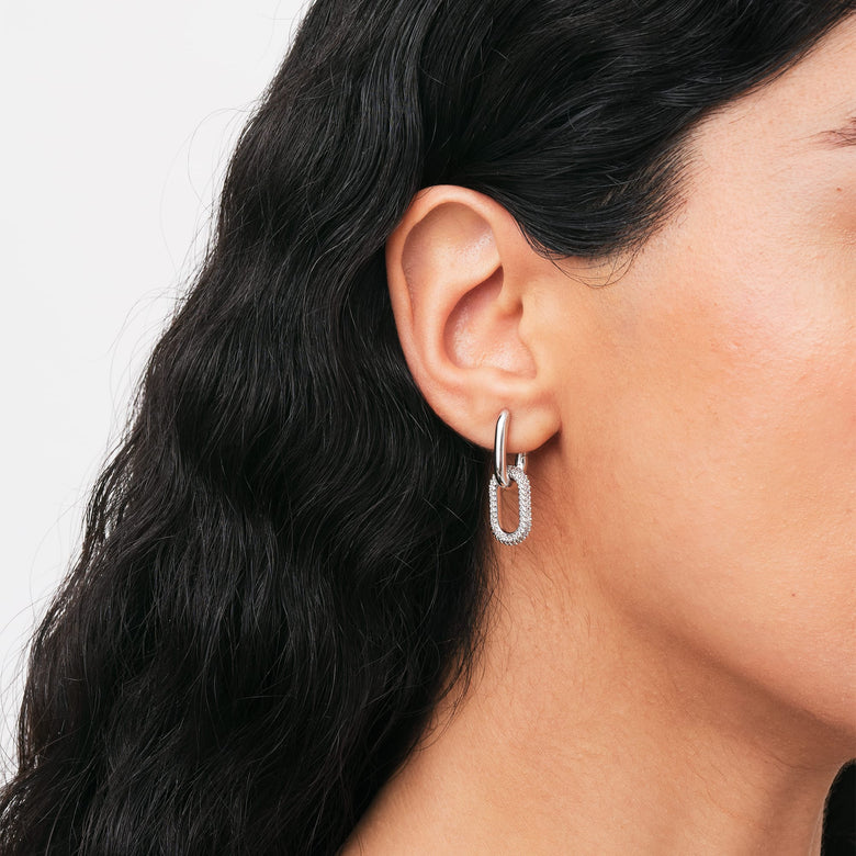 Crystal Link Earrings Silver worn on a woman, showcasing the chunky chain-inspired shape and sparkling cubic zirconia accents against polished silver, styled for everyday elegance.