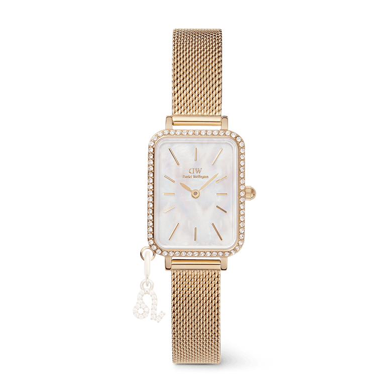 Quadro Crystal Zodiac Evergold gold watch for women with a slim rectangular case, crystal-framed bezel, mother of pearl dial, and a gold mesh strap featuring an interchangeable zodiac charm.