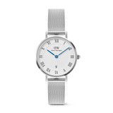 Petite Roman Numerals Date Silver features a 28mm stainless steel case, a textured white dial with Roman numerals, blue hands, a date window at 6 o’clock, and a slim adjustable silver mesh strap.