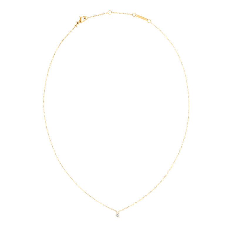Mirelle Solitaire Necklace Gold with a fine adjustable gold chain and a single white cubic zirconia pendant, shown laid flat to highlight its minimalist and elegant design.