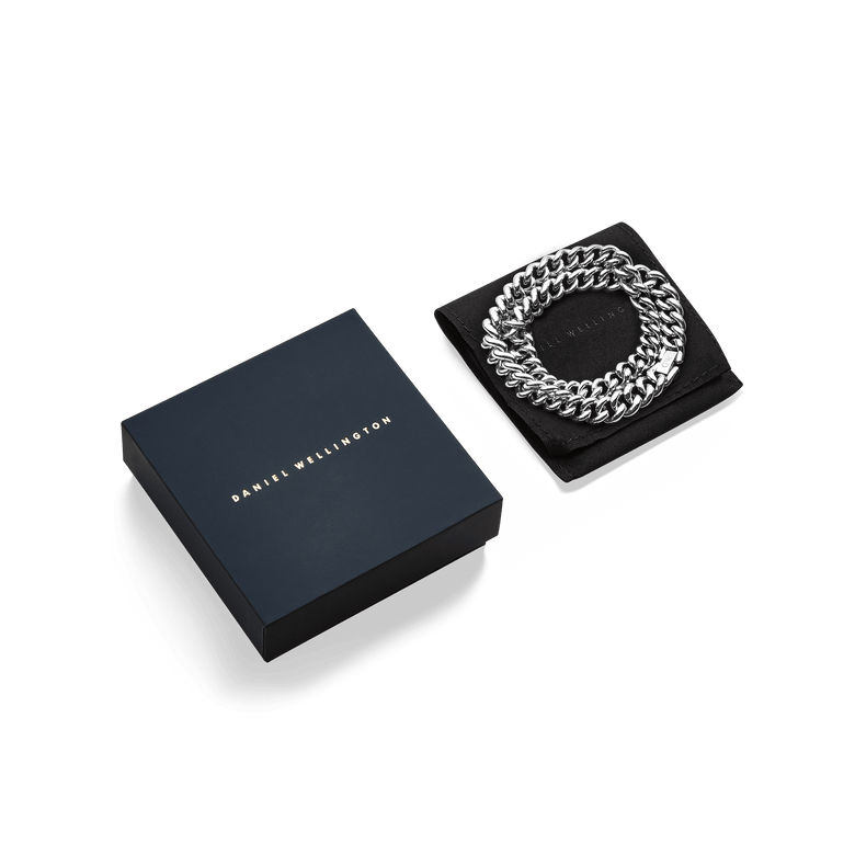 Chunky Chain Necklace Silver displayed coiled on a black pouch next to a sleek Daniel Wellington gift box, highlighting its polished links and elegant presentation for gifting.