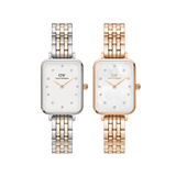Two Daniel Wellington Quadro Lumine 5-link ladies watches, one in rose gold and one in two-tone silver and gold, both featuring rectangular faces, white dials with crystal hour markers, and elegant five-link metal bracelets.